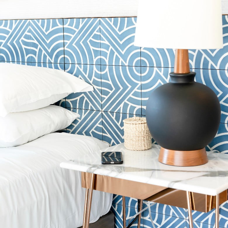 Home decor hashtags - modern bedroom with a blue and white patterned wallpaper.